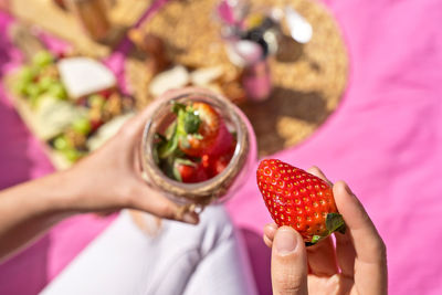 Cropped hand of woman holding food