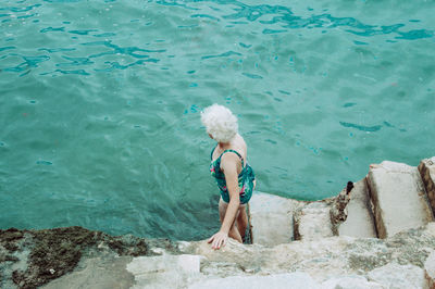 High angle view of woman standing at beach