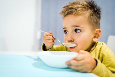 Portrait of boy with ice cream in bowl