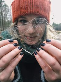 Portrait of young woman holding ice