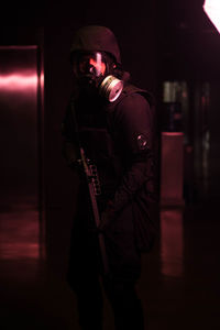 Man holding illuminated lighting equipment at night