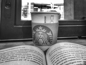 Close-up of open book on table at home