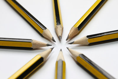 Close-up of colored pencils against white background