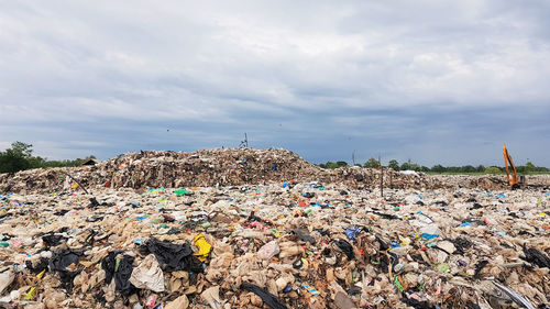 View of garbage on field against cloudy sky