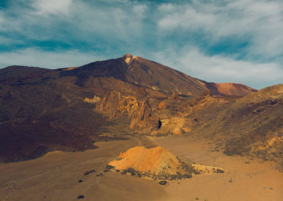 Scenic view of volcanic mountain against sky