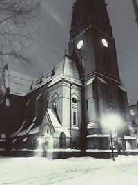 Low angle view of illuminated building during winter