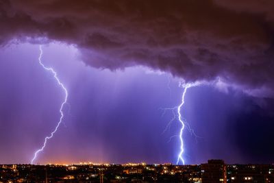 Lightning over cityscape at night