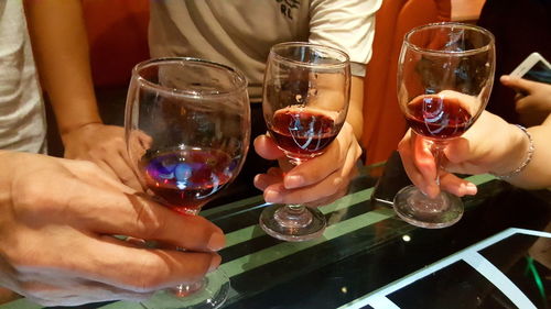 Close-up of hand holding beer glass