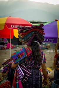 Rear view of woman with multi colored umbrella