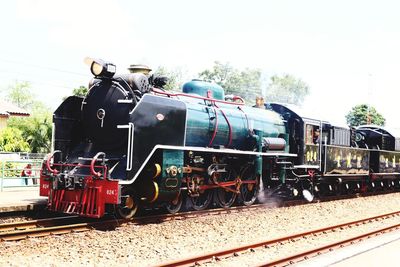 Train on railroad tracks against sky