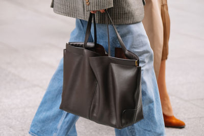 Midsection of woman standing on road