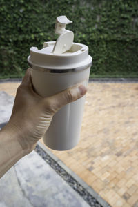 Cropped image of person holding coffee cup