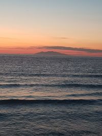 Scenic view of sea against romantic sky at sunset