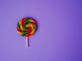 Low angle view of multi colored balloons against blue background