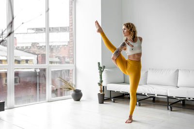 Beautiful woman performing yoga at home