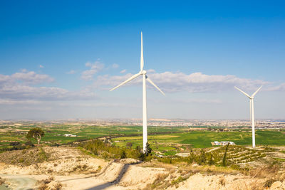 Windmill on field against sky