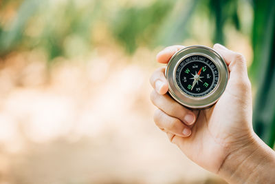 Cropped hand holding navigational compass