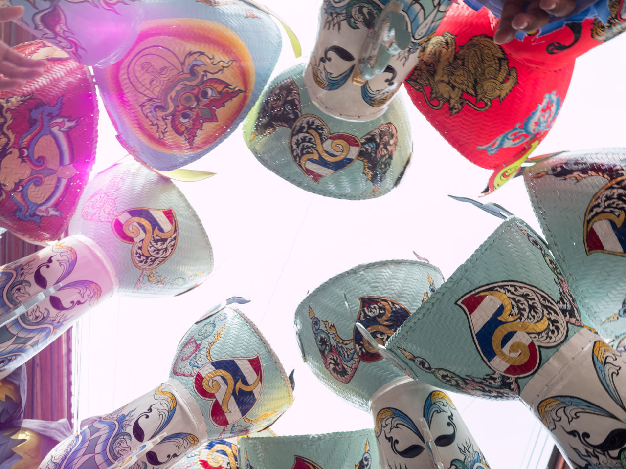 LOW ANGLE VIEW OF MULTI COLORED DECORATIONS HANGING AT MARKET STALL