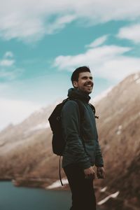 Full length of man standing on mountain against sky