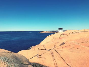 Scenic view of sea against clear blue sky