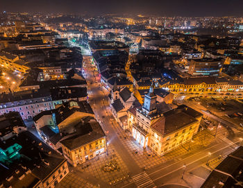 High angle view of city lit up at night