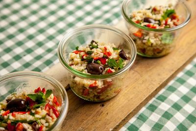 High angle view of rice and vegetables served in bowl on wood