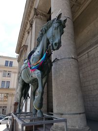 Low angle view of statue against building in city