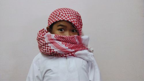 Portrait of a boy covering face