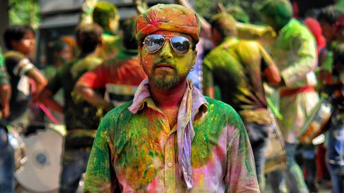 Full length portrait of man with multi colored leaves