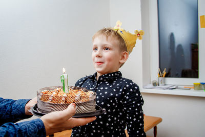 Portrait of cute girl blowing birthday cake