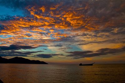 Scenic view of sea against cloudy sky