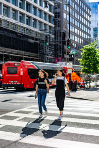 Full length of woman walking on city street