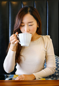 Young woman drinking coffee cup