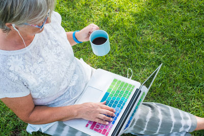 Midsection of woman holding coffee cup