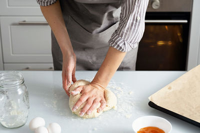 Midsection of woman preparing food on table