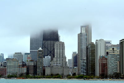 Buildings in city against sky