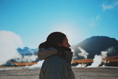 Woman standing on top of mountain