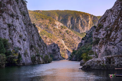 Scenic view of river amidst mountains against sky