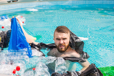Portrait of young man in swimming pool