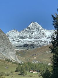 Scenic view of snowcapped mountains against clear sky