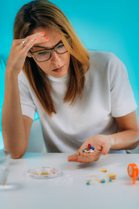 Female patient failing to follow medical advice, demonstrating prescribed medicine