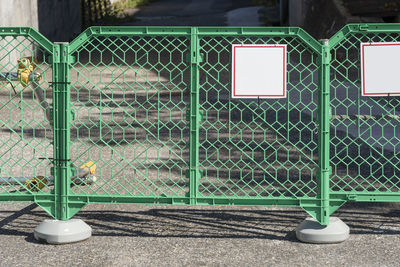 Metal grate on chainlink fence