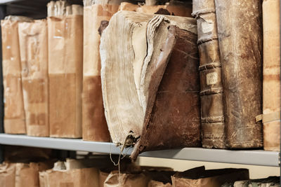 Old worn 17th century books on a shelf in the library's shelfs