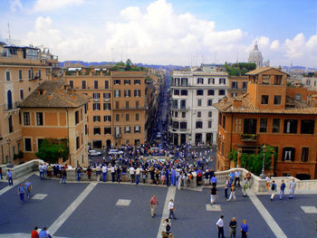 High angle view of people on road by buildings in city