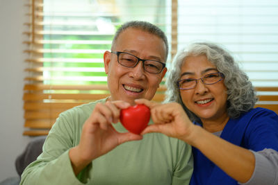 Portrait of smiling woman holding apple