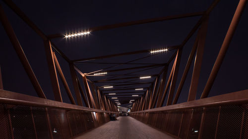 Illuminated tunnel at night