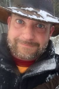 Close-up portrait of young man in snow