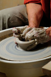 Midsection of man working in mud