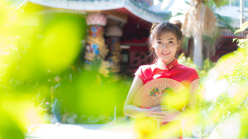 Portrait of smiling young woman standing in store