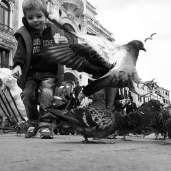 Low angle view of people on street against sky
